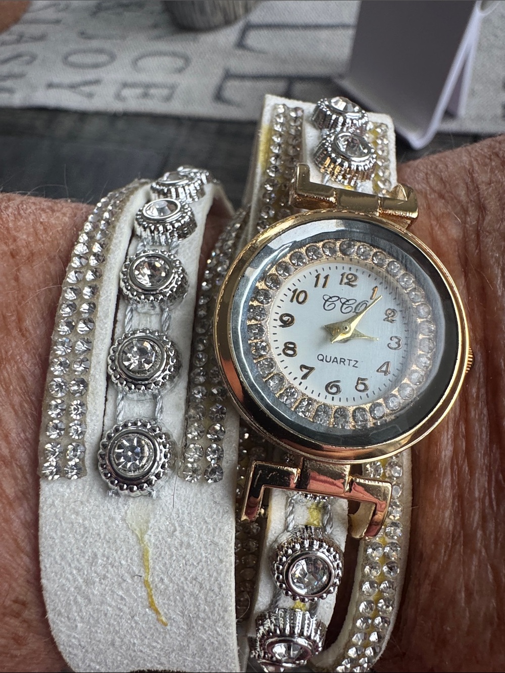 Gold and White Crystal Wrap Bracelet Watch with stones.